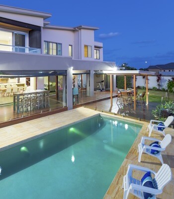 Modern multilevel house exterior with pool